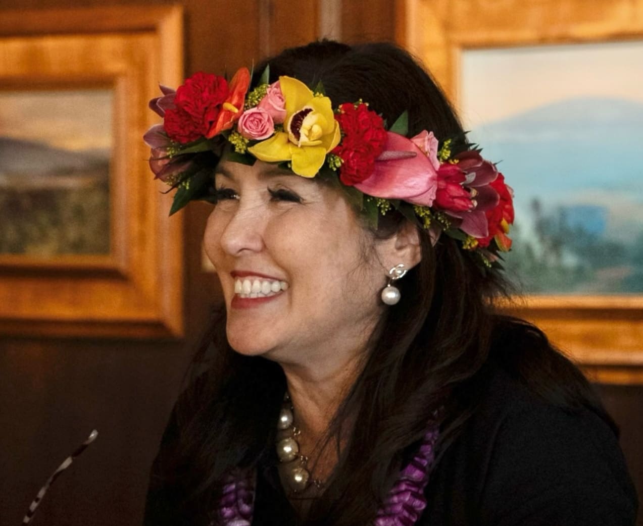 Smiling woman wearing a flower crown.